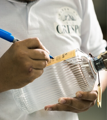 Signing a CRESPO gin bottle during production